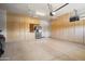 Spacious garage with ample cabinet storage, epoxy floor, and stainless steel refrigerator at 27280 N Makena Pl, Peoria, AZ 85383