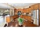 Beautiful kitchen features an island sink, granite counters, stainless appliances, wooden cabinetry, and eat-in breakfast nook at 27280 N Makena Pl, Peoria, AZ 85383