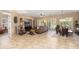 Spacious living room with tile flooring, plantation shutters, and an open layout to the dining area at 27280 N Makena Pl, Peoria, AZ 85383