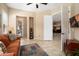 Comfortable living room with tiled floors, ceiling fan and a view into other rooms at 27280 N Makena Pl, Peoria, AZ 85383