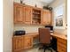 Cozy home office featuring custom wood built-ins and a comfortable workspace at 27280 N Makena Pl, Peoria, AZ 85383