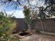 Landscaped backyard featuring a small fountain with brickwork and mature trees against the wall at 2833 E Emile Zola Ave, Phoenix, AZ 85032