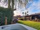 Lush backyard oasis with a hot tub, swimming pool, and mature landscaping, offering a private retreat at 2833 E Emile Zola Ave, Phoenix, AZ 85032