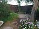 Lush backyard featuring a stone patio, mature landscaping, string lights and an abundance of greenery for privacy and ambiance at 2833 E Emile Zola Ave, Phoenix, AZ 85032