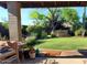 Beautiful backyard featuring green lawn, mature landscaping, and a relaxing hot tub at 2833 E Emile Zola Ave, Phoenix, AZ 85032