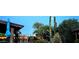 Backyard at dusk with desert landscaping, string lights, and a covered patio at 2833 E Emile Zola Ave, Phoenix, AZ 85032