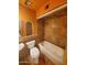 Bright bathroom with orange walls, a bathtub, and a stylish stone-tiled shower at 2833 E Emile Zola Ave, Phoenix, AZ 85032