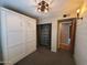 Neutral toned bedroom features a murphy bed and closet with gold curtains at 2833 E Emile Zola Ave, Phoenix, AZ 85032