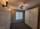Bedroom featuring updated lighting, white shiplap accent wall, and a murphy bed at 2833 E Emile Zola Ave, Phoenix, AZ 85032