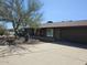 Exterior view of house with a large tree and a well-manicured xeriscape landscape at 2833 E Emile Zola Ave, Phoenix, AZ 85032