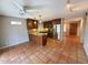 Bright, open kitchen with stainless steel appliances, warm cabinets, bar seating and terracotta tile flooring at 2833 E Emile Zola Ave, Phoenix, AZ 85032