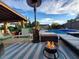 Inviting pool area featuring a cozy fire pit, lounge chairs, heater and a well-maintained patio, perfect for relaxation at 2833 E Emile Zola Ave, Phoenix, AZ 85032