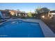 Beautiful backyard oasis with a sparkling pool, lush greenery, comfortable seating, and a built-in bar area at 2833 E Emile Zola Ave, Phoenix, AZ 85032