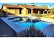 Beautiful backyard pool with clear blue water, surrounded by greenery and a covered patio at 2833 E Emile Zola Ave, Phoenix, AZ 85032