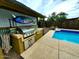 Outdoor kitchen and barbecue area adjacent to the pool at 2833 E Emile Zola Ave, Phoenix, AZ 85032