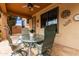 Covered back patio with a dining set overlooking a landscaped backyard at 3023 E Silversmith Trl, San Tan Valley, AZ 85143