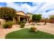 Landscaped backyard featuring rocks, plants, and an outdoor living space at 3023 E Silversmith Trl, San Tan Valley, AZ 85143