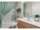 Well-lit bathroom featuring a shower with curtain and white sink and toilet at 3023 E Silversmith Trl, San Tan Valley, AZ 85143