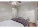 Bedroom with a decorative metal bed frame, ceiling fan, and white walls at 3023 E Silversmith Trl, San Tan Valley, AZ 85143