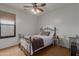 Cozy bedroom with a decorative metal bed frame, ceiling fan, and natural light from the window at 3023 E Silversmith Trl, San Tan Valley, AZ 85143