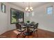 Charming dining room features a round table with seating for four and a view of the backyard at 3023 E Silversmith Trl, San Tan Valley, AZ 85143