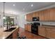 Bright kitchen featuring stainless steel appliances, tile floors and adjacent dining area at 3023 E Silversmith Trl, San Tan Valley, AZ 85143