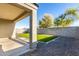 View of the backyard with an expansive gravel area surrounding manicured synthetic grass and block wall at 30323 W Sheila Ln, Buckeye, AZ 85396