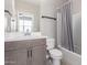 A bathroom with a single sink vanity, toilet, and a shower-tub with a curtain at 30323 W Sheila Ln, Buckeye, AZ 85396