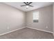 Neutral bedroom with a ceiling fan, a window with blinds, carpet, and base trim at 30323 W Sheila Ln, Buckeye, AZ 85396