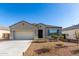 Charming single-story home with a well-maintained front yard and a two-car garage at 30323 W Sheila Ln, Buckeye, AZ 85396