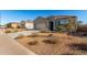 Quaint single-story house with well-manicured desert landscaping and blue shutters at 30323 W Sheila Ln, Buckeye, AZ 85396