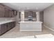 Well-lit kitchen with a large island, ample counter space, and stainless steel appliances at 30323 W Sheila Ln, Buckeye, AZ 85396