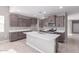 Modern kitchen featuring stainless steel appliances, a center island, and ample cabinet space at 30323 W Sheila Ln, Buckeye, AZ 85396