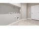A laundry room with tile flooring, shelving, and utility hook-ups at 30323 W Sheila Ln, Buckeye, AZ 85396