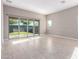 Living area with tile flooring, ample natural light, and sliding glass doors to the outdoor space at 30323 W Sheila Ln, Buckeye, AZ 85396