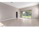Bright living room featuring tile flooring and sliding glass doors that lead to the backyard at 30323 W Sheila Ln, Buckeye, AZ 85396