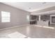 Bright, open-concept living area with tile flooring and view of the modern kitchen at 30323 W Sheila Ln, Buckeye, AZ 85396