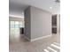 Open floor plan living room and kitchen with tile flooring and sliding glass doors to backyard at 30323 W Sheila Ln, Buckeye, AZ 85396
