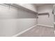 A walk-in closet features carpet, storage shelves, and ample space for organizing clothes and accessories at 30323 W Sheila Ln, Buckeye, AZ 85396