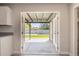 A view from the kitchen to the covered back patio featuring green turf and a block wall for ultimate privacy at 3437 E Acoma Dr, Phoenix, AZ 85032