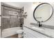 Beautiful bathroom featuring tiled shower with built-in niche and granite countertop at 3437 E Acoma Dr, Phoenix, AZ 85032