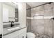 Updated bathroom featuring a granite countertop, tiled shower, and modern fixtures at 3437 E Acoma Dr, Phoenix, AZ 85032