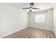 Bedroom with wood-look flooring, fan and window at 3437 E Acoma Dr, Phoenix, AZ 85032