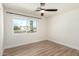 Bedroom featuring a large window and wood-look flooring at 3437 E Acoma Dr, Phoenix, AZ 85032
