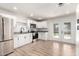 Remodeled kitchen featuring stainless steel appliances, white cabinets, and views of the backyard through French doors at 3437 E Acoma Dr, Phoenix, AZ 85032