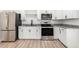 Updated kitchen featuring stainless steel appliances, white cabinets, and a modern subway tile backsplash at 3437 E Acoma Dr, Phoenix, AZ 85032