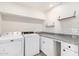 Laundry room including washer, dryer, countertop and shelving at 3437 E Acoma Dr, Phoenix, AZ 85032