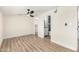 The main bedroom has wood-look floors, a fan, and ensuite access to the main bathroom and walk-in closet at 3437 E Acoma Dr, Phoenix, AZ 85032