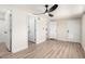 The main bedroom has wood-look floors, a fan, and ensuite access to the main bathroom and walk-in closet at 3437 E Acoma Dr, Phoenix, AZ 85032