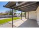The patio boasts concrete tiles, an outdoor ceiling, and a view of a lawn and a shed at 3437 E Acoma Dr, Phoenix, AZ 85032